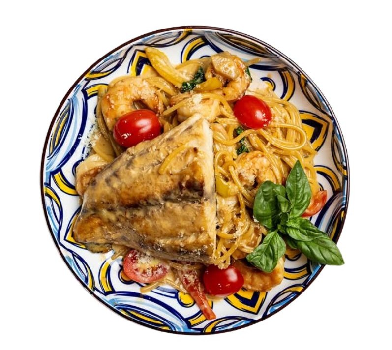 Pan-seared salmon and prawn linguine pasta in creamy sauce with fresh herbs